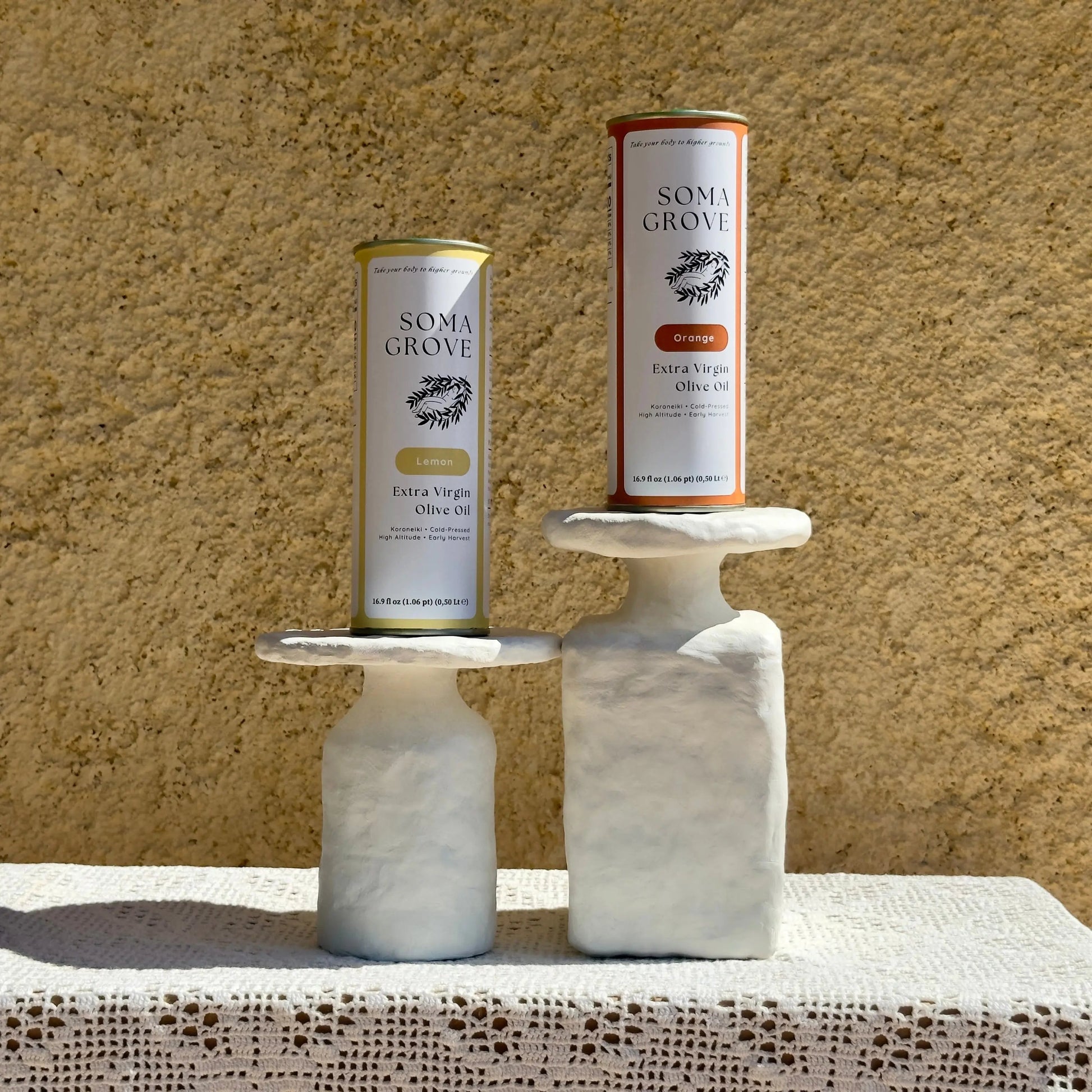 Soma Grove Citrus Olive Oil Bundle on marble stands with a rustic backdrop.