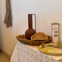 An indoor table featuring sourdough bread served with Classic Extra Virgin Olive Oil by Soma Grove.