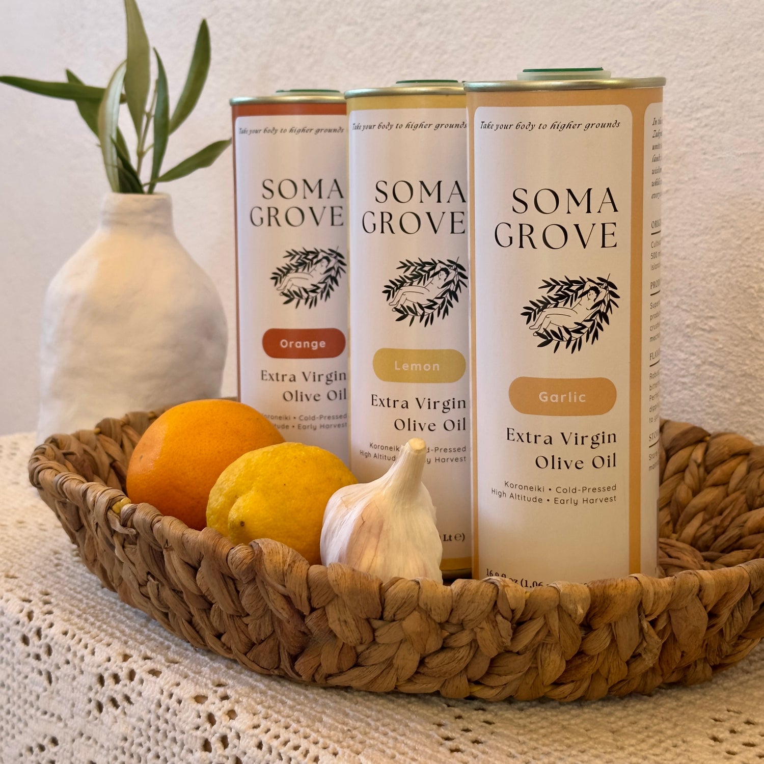 A basket of Soma Grove olive oils, featuring garlic, lemon, and orange flavors.