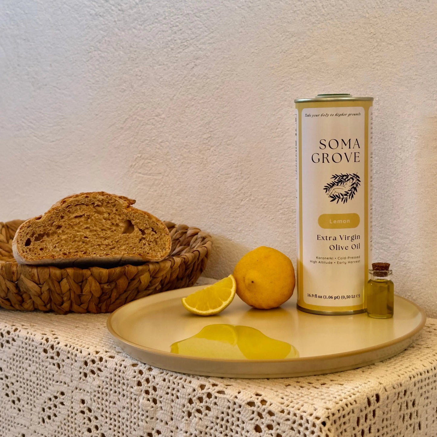 An indoor table featuring sourdough bread served with Lemon Extra Virgin Olive Oil by Soma Grove.