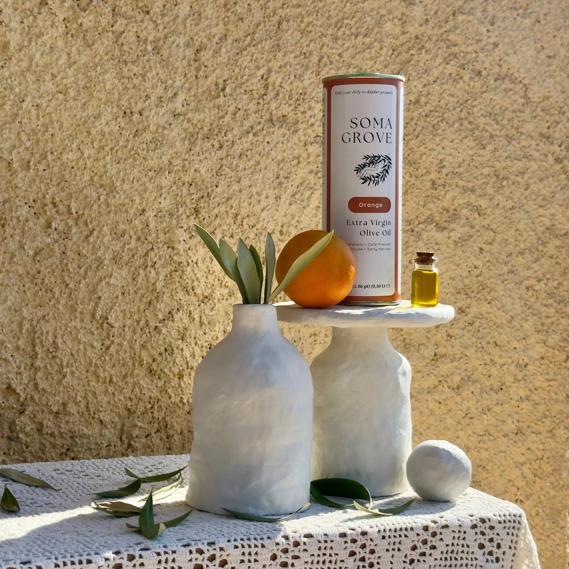 Soma Grove Orange olive on a textured surface with decorative elements.